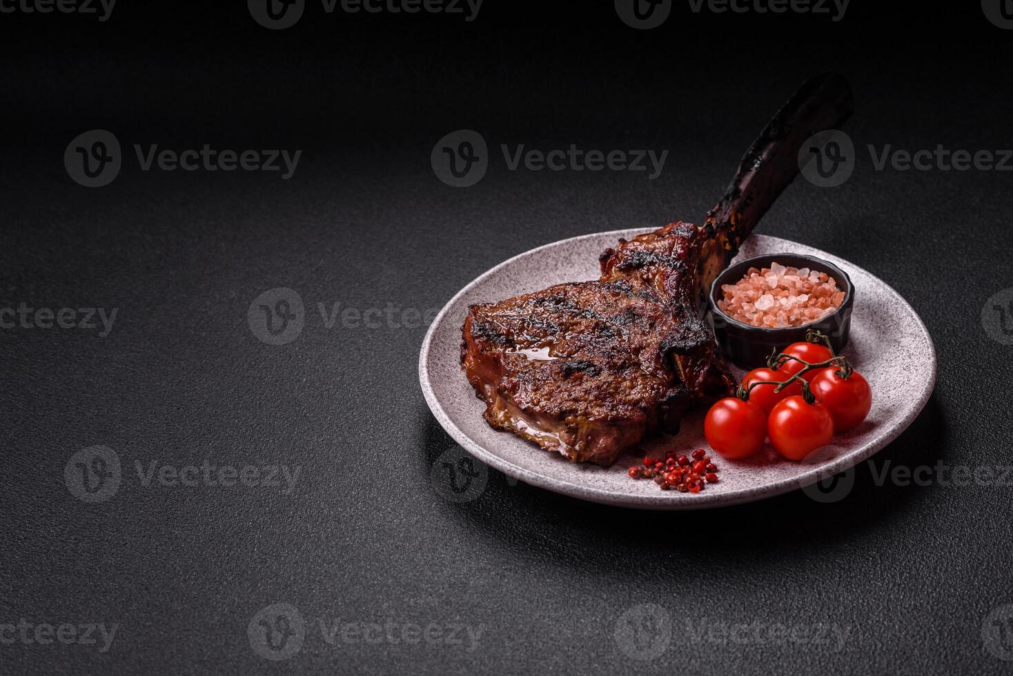 Grilled wagyu beef tomahawk steak with salt, spices and herbs photo