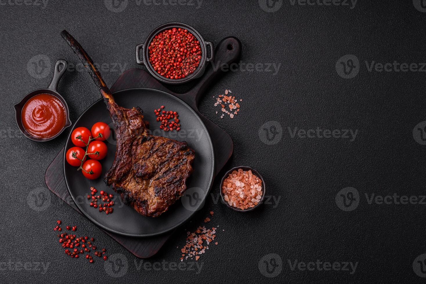 Grilled wagyu beef tomahawk steak with salt, spices and herbs photo