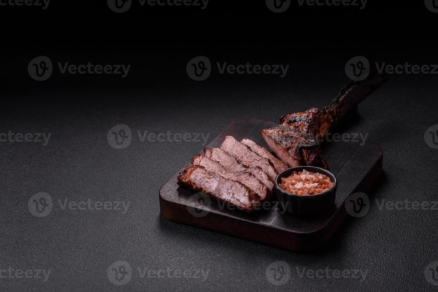 Grilled wagyu beef tomahawk steak with salt, spices and herbs photo
