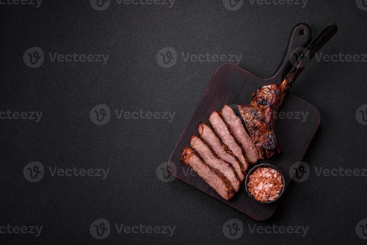 Grilled wagyu beef tomahawk steak with salt, spices and herbs photo