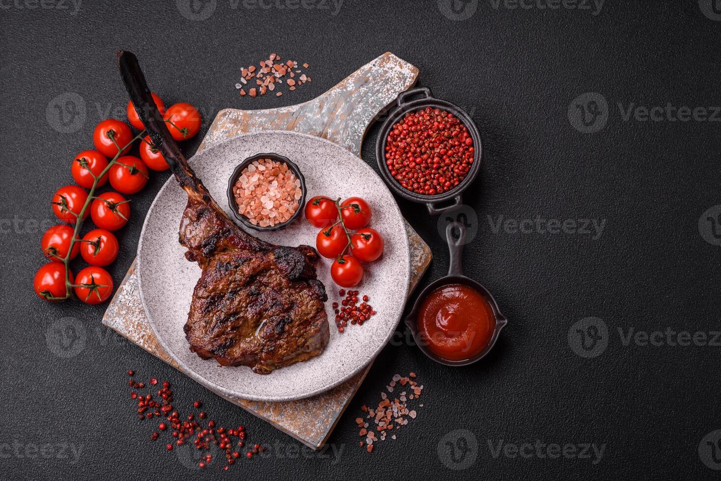 Grilled wagyu beef tomahawk steak with salt, spices and herbs photo