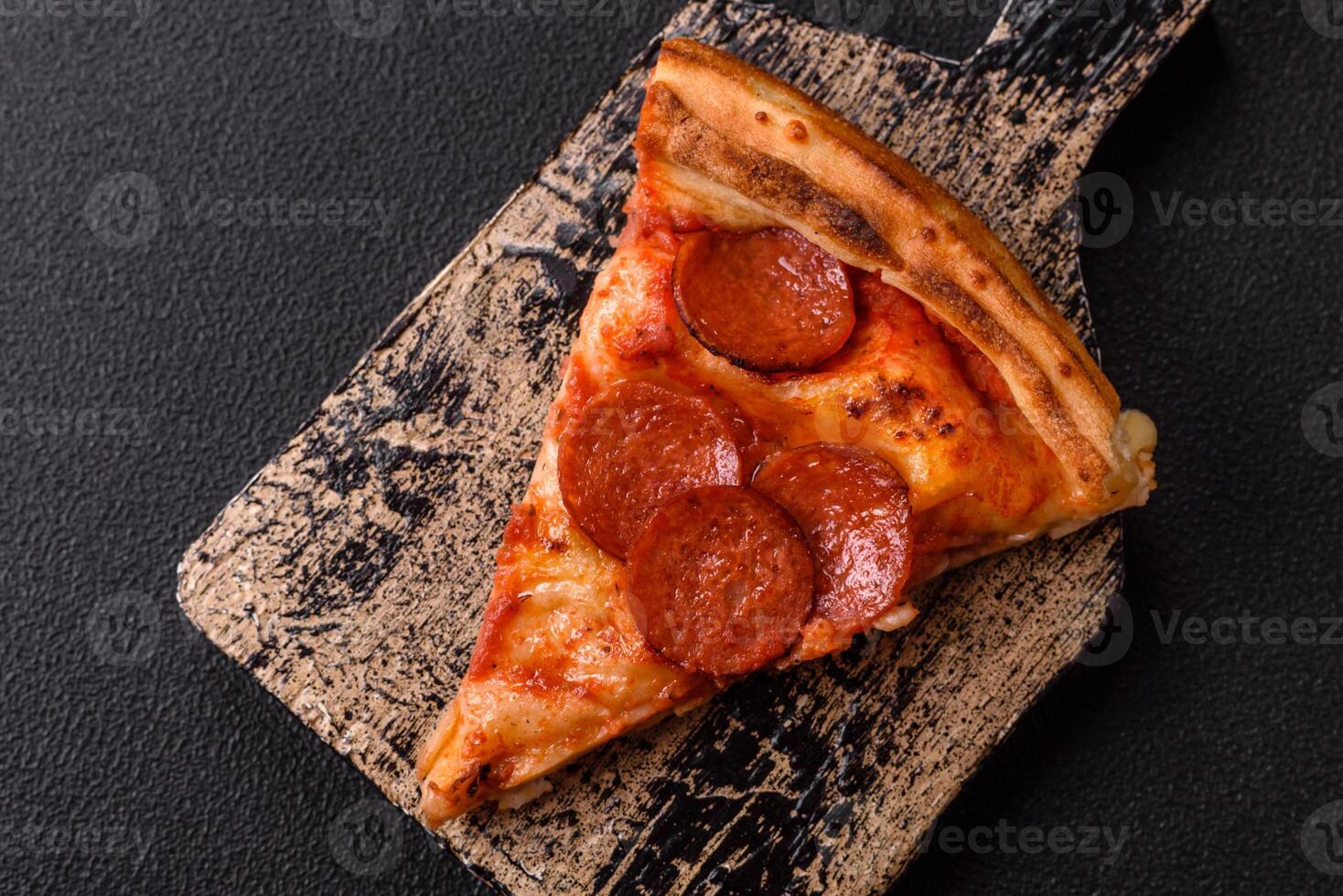 Pepperoni pizza with sausage, mozzarella cheese, tomatoes, salt and spices photo