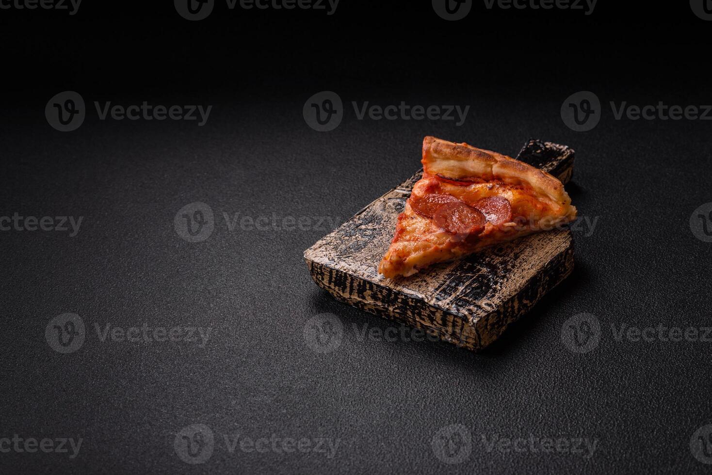 Pepperoni pizza with sausage, mozzarella cheese, tomatoes, salt and spices photo