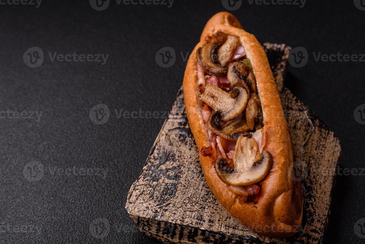 Hotdog with grilled sausage with bacon and mushrooms photo