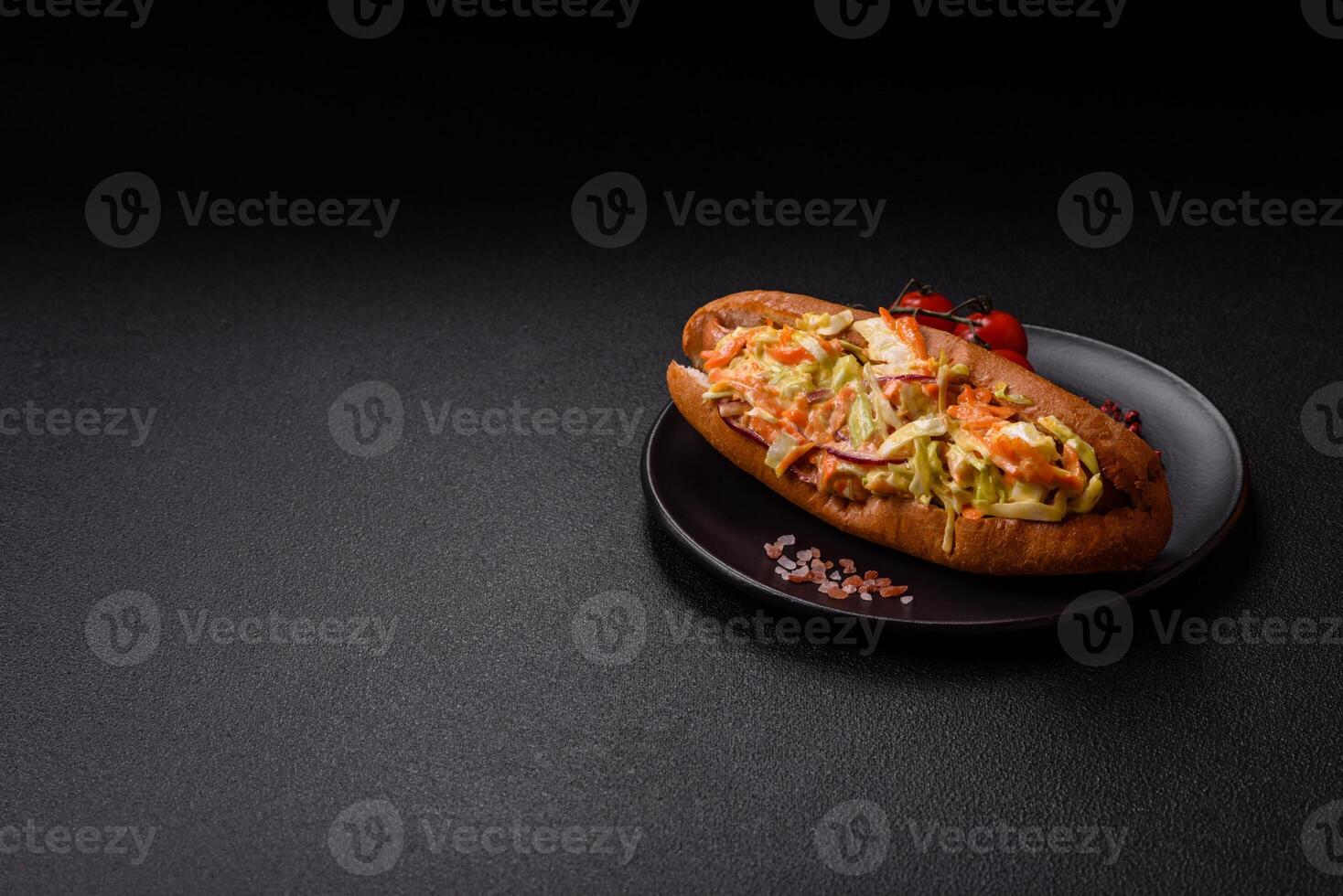 Hotdog with grilled sausage with cabbage, carrots and onions photo