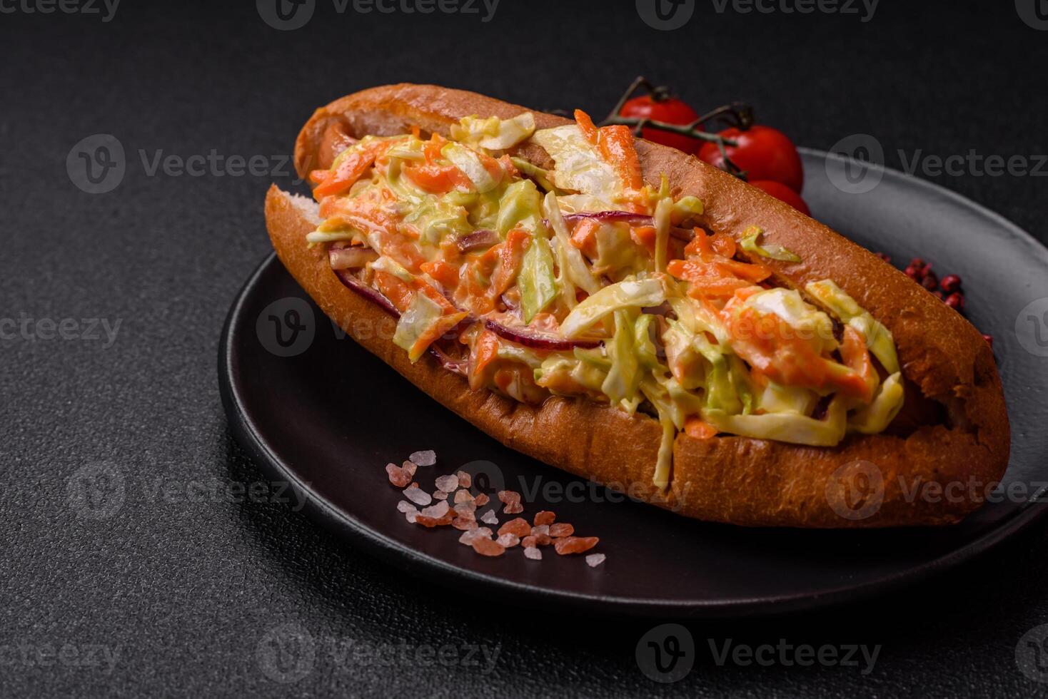 Hotdog with grilled sausage with cabbage, carrots and onions photo