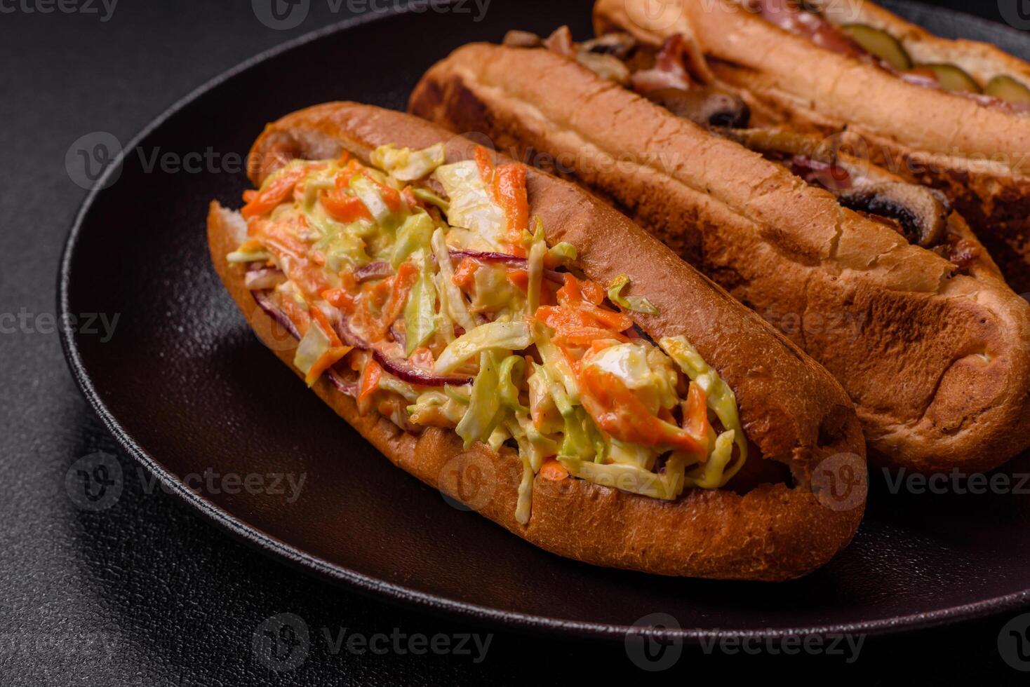 Hotdog with grilled sausage with cabbage, carrots and onions photo