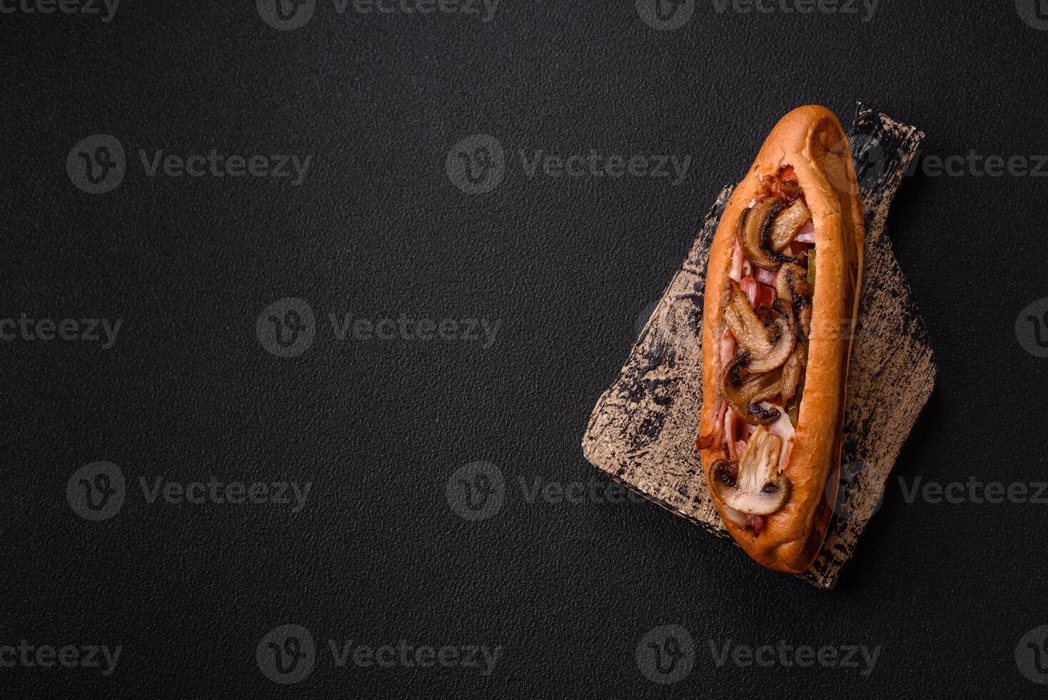 Hotdog with grilled sausage with bacon and mushrooms photo