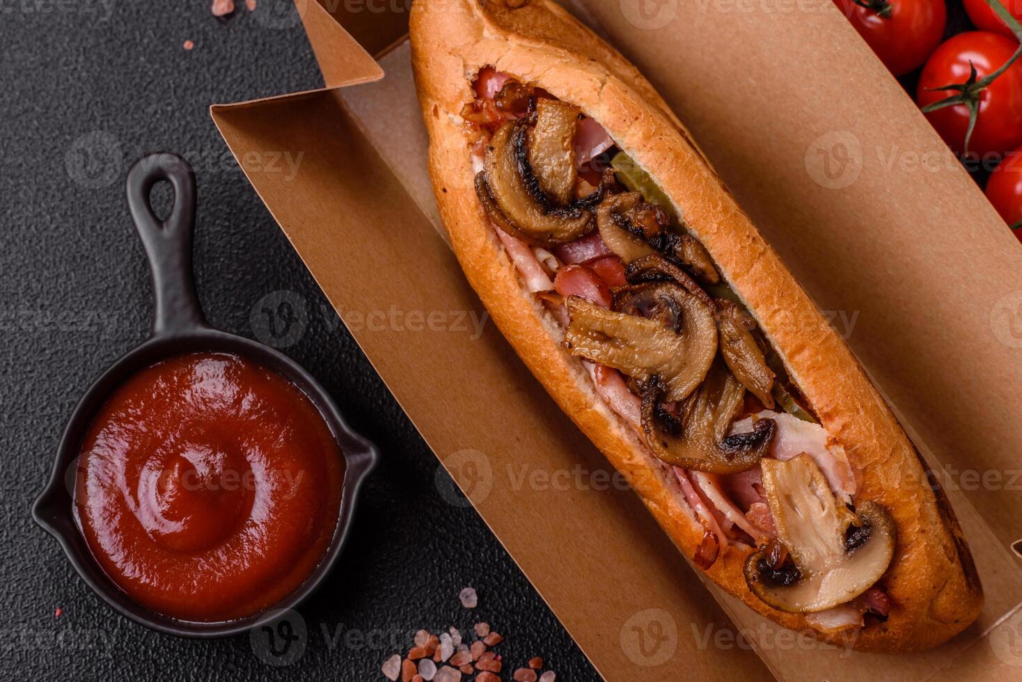 Hotdog with grilled sausage with bacon and mushrooms photo