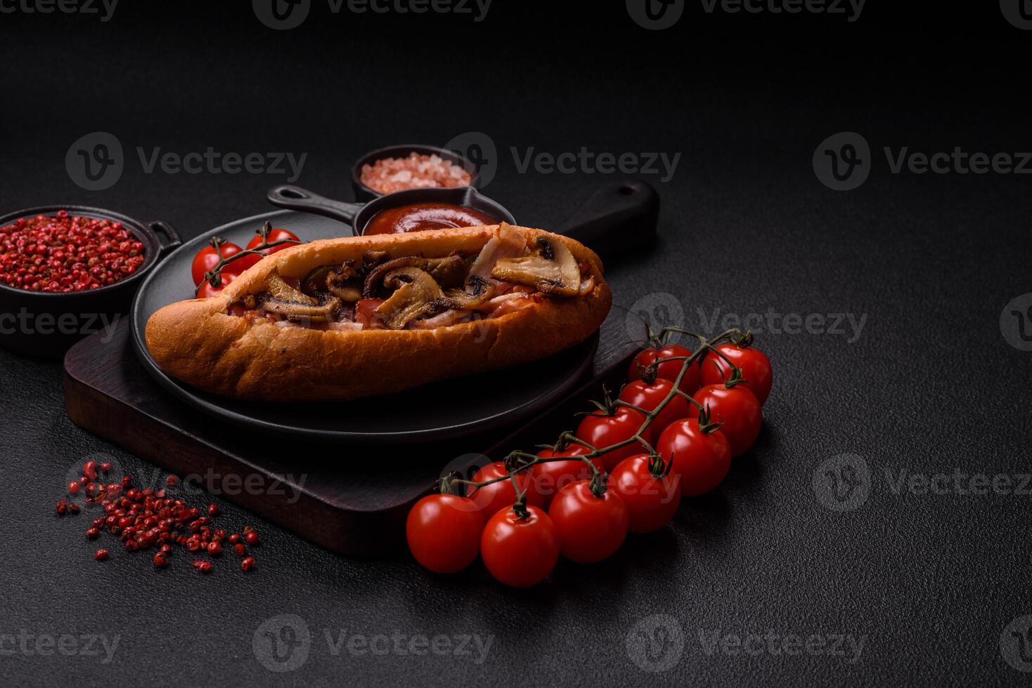 Hotdog with grilled sausage with bacon and mushrooms photo