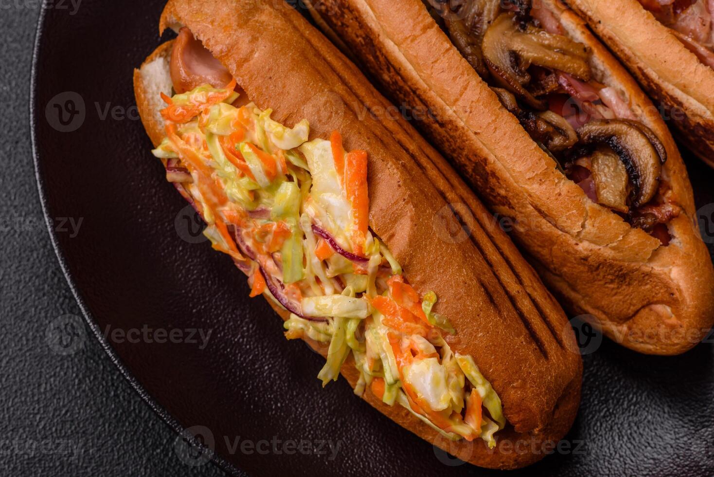 Hotdog with grilled sausage with cabbage, carrots and onions photo