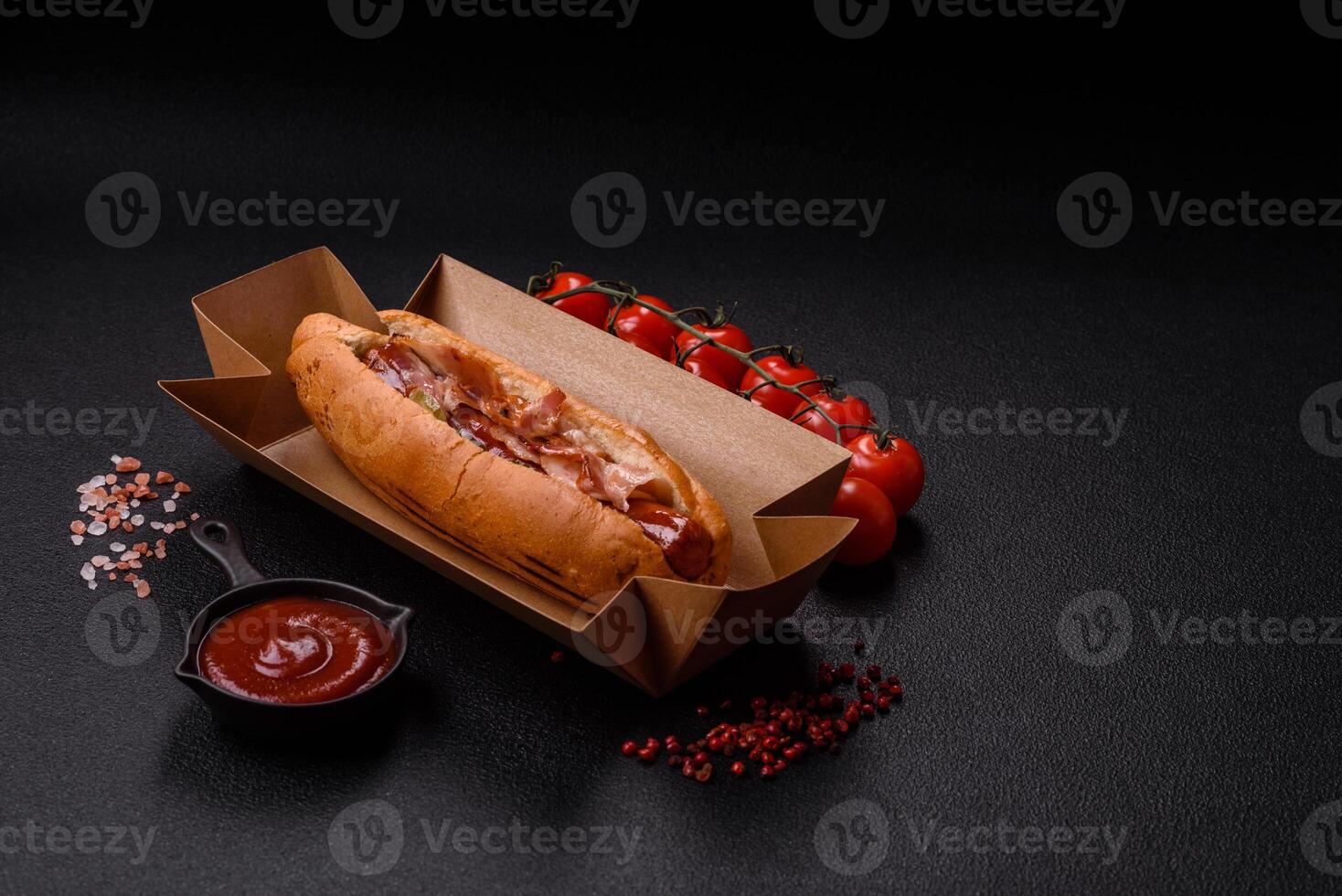 Hotdog with grilled sausage with bacon and mushrooms photo