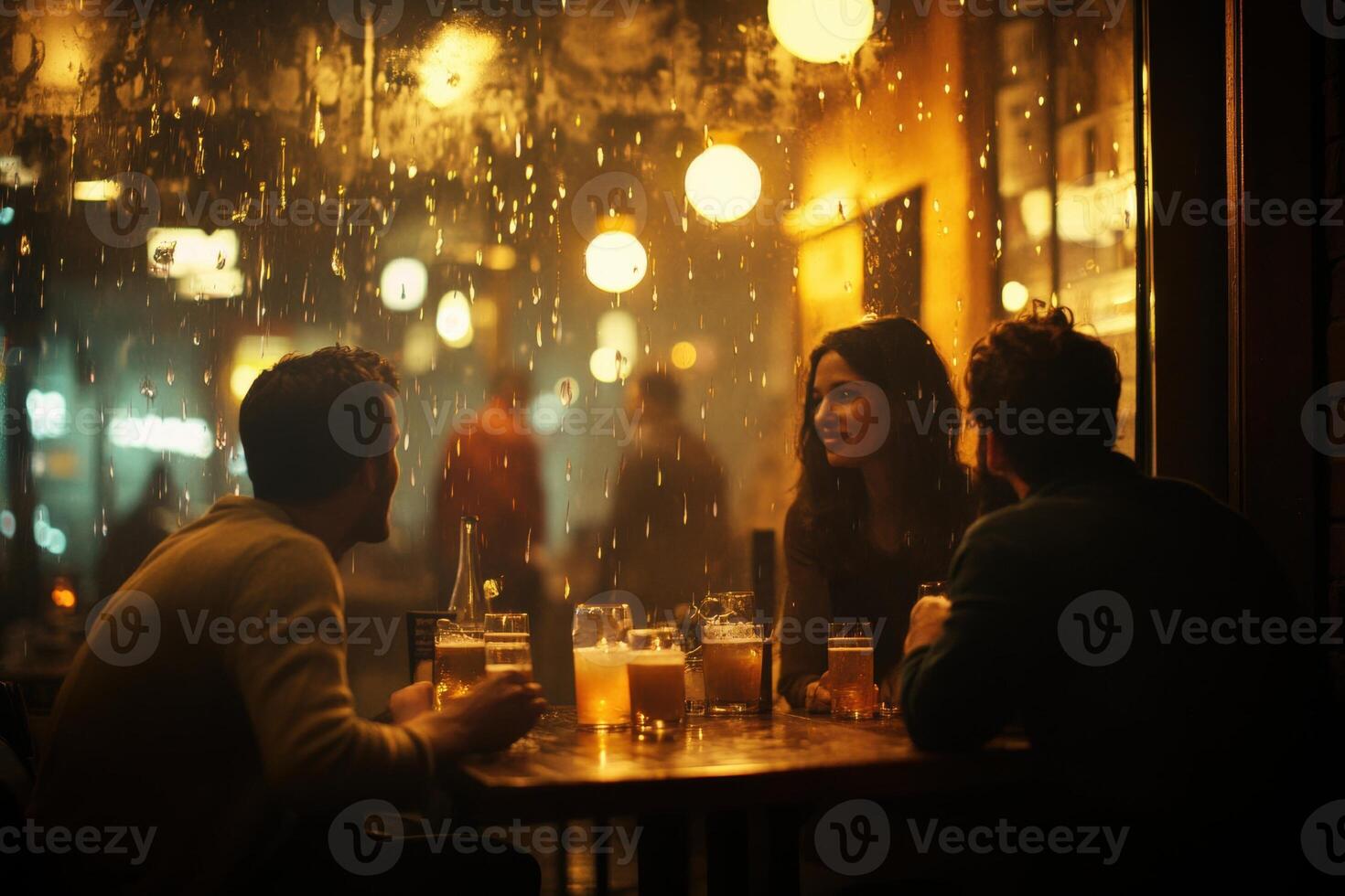 Friends drinking beer in a pub on a rainy night photo