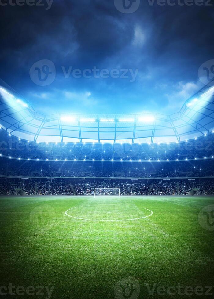 An empty soccer stadium with lights on the field photo