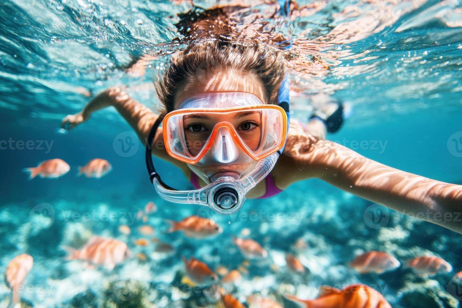 Young girl snorkeling in tropical sea exploring underwater marine life photo