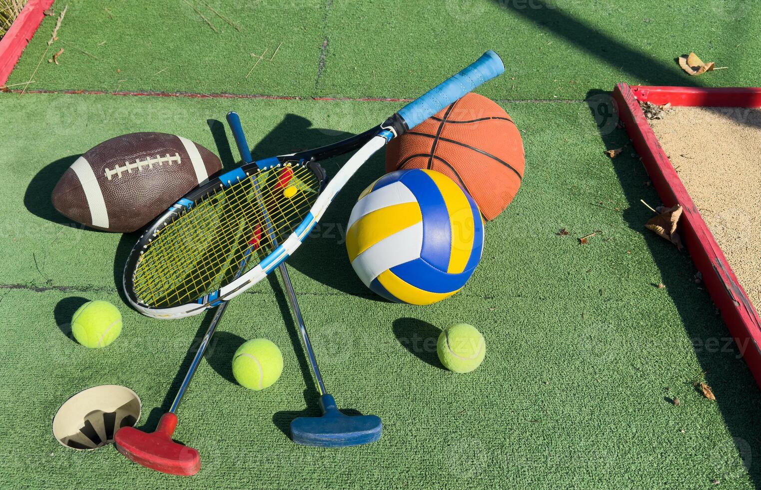 Different sport equipment on green grass, flat lay. Space for text photo