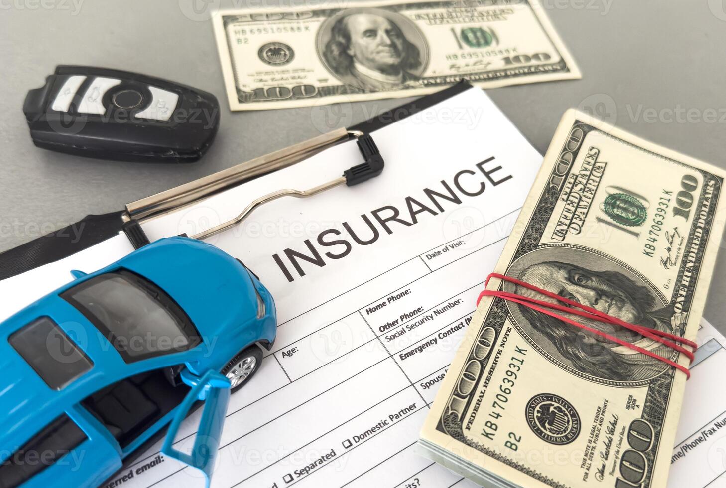 toy car with money on an insurance contract. Safety concept. photo