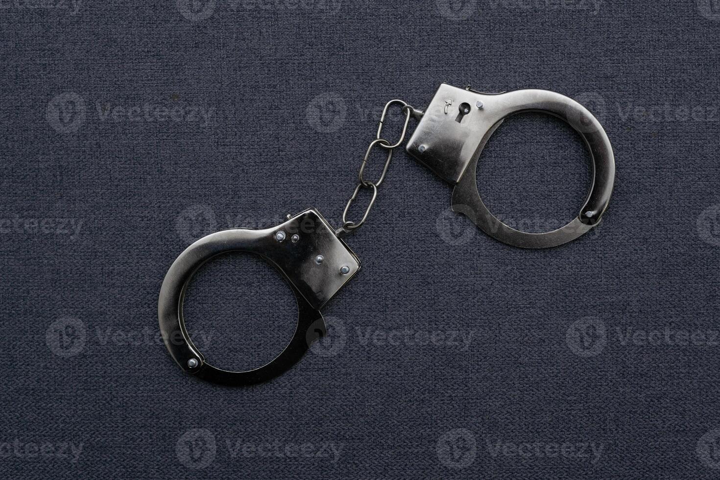 Police handcuffs on the USA flag, close-up photo