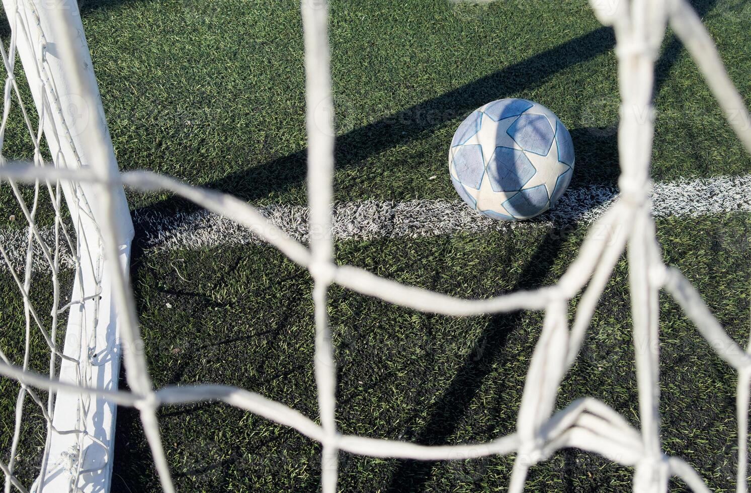 Soccer ball on a grass football field photo