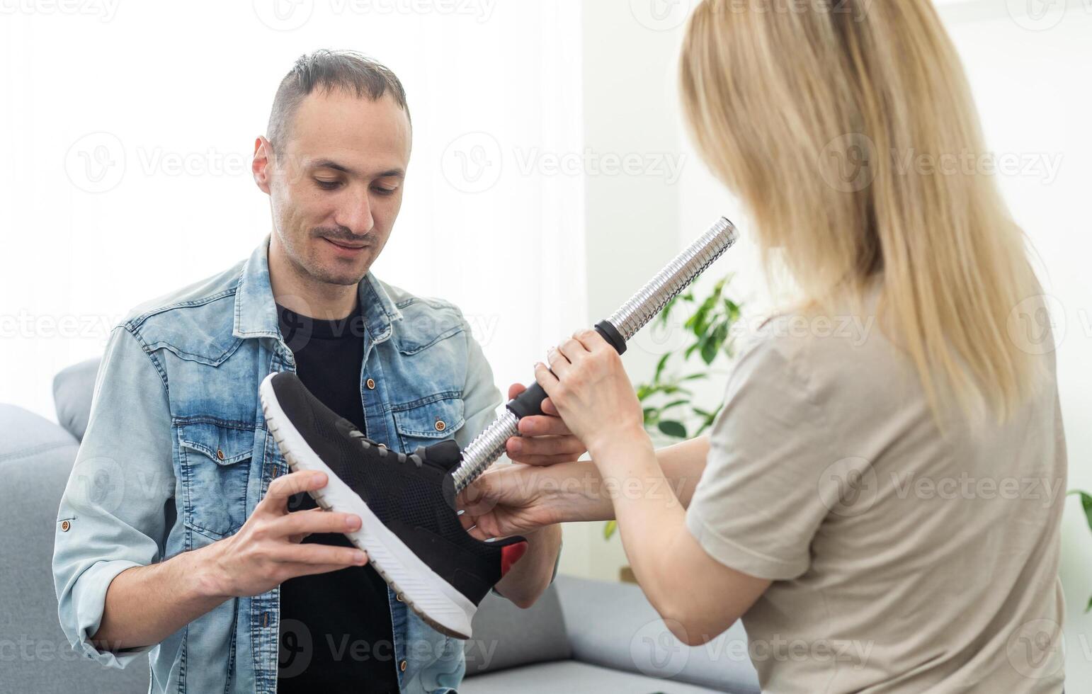 Modern Hospital Physical Therapy. Doctor Uses Tablet Computer, Helps Disabled Patient with Injury Walk on Treadmill Wearing Advanced Robotic Exoskeleton Legs. Physiotherapy Rehabilitation Technology photo