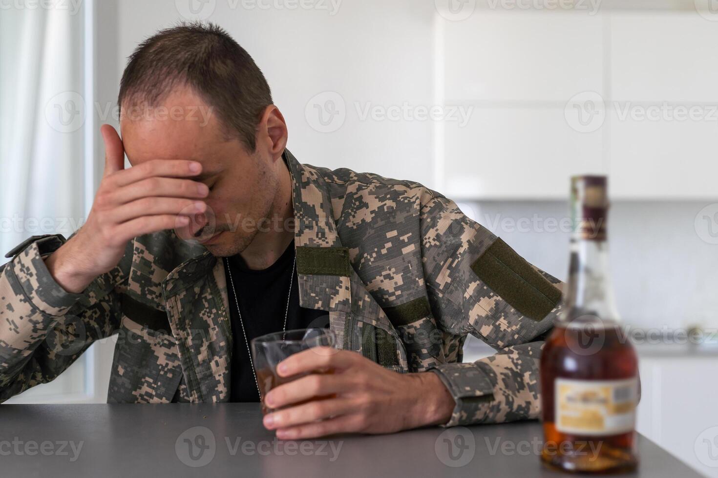Upset young man drinker alcoholic sitting at bar counter with glass drinking whiskey alone, sad depressed addicted drunk guy having problem suffer from alcohol addiction abuse, alcoholism concept photo