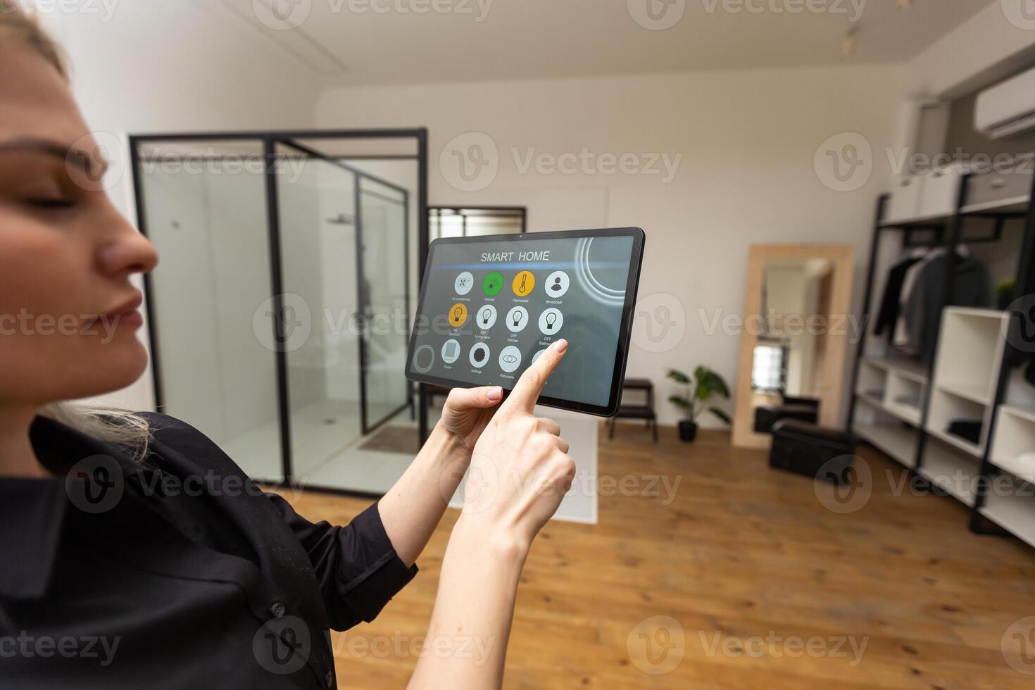 Digital composite of Hands using smart home application on tablet PC photo