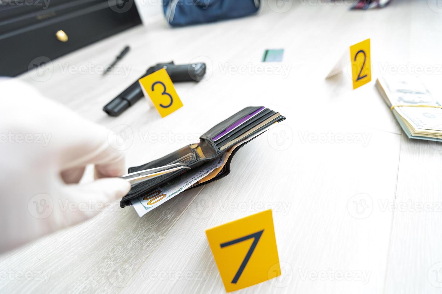 Crime scene investigation, picking up the tossed syringe and putting it to the plastic bag photo