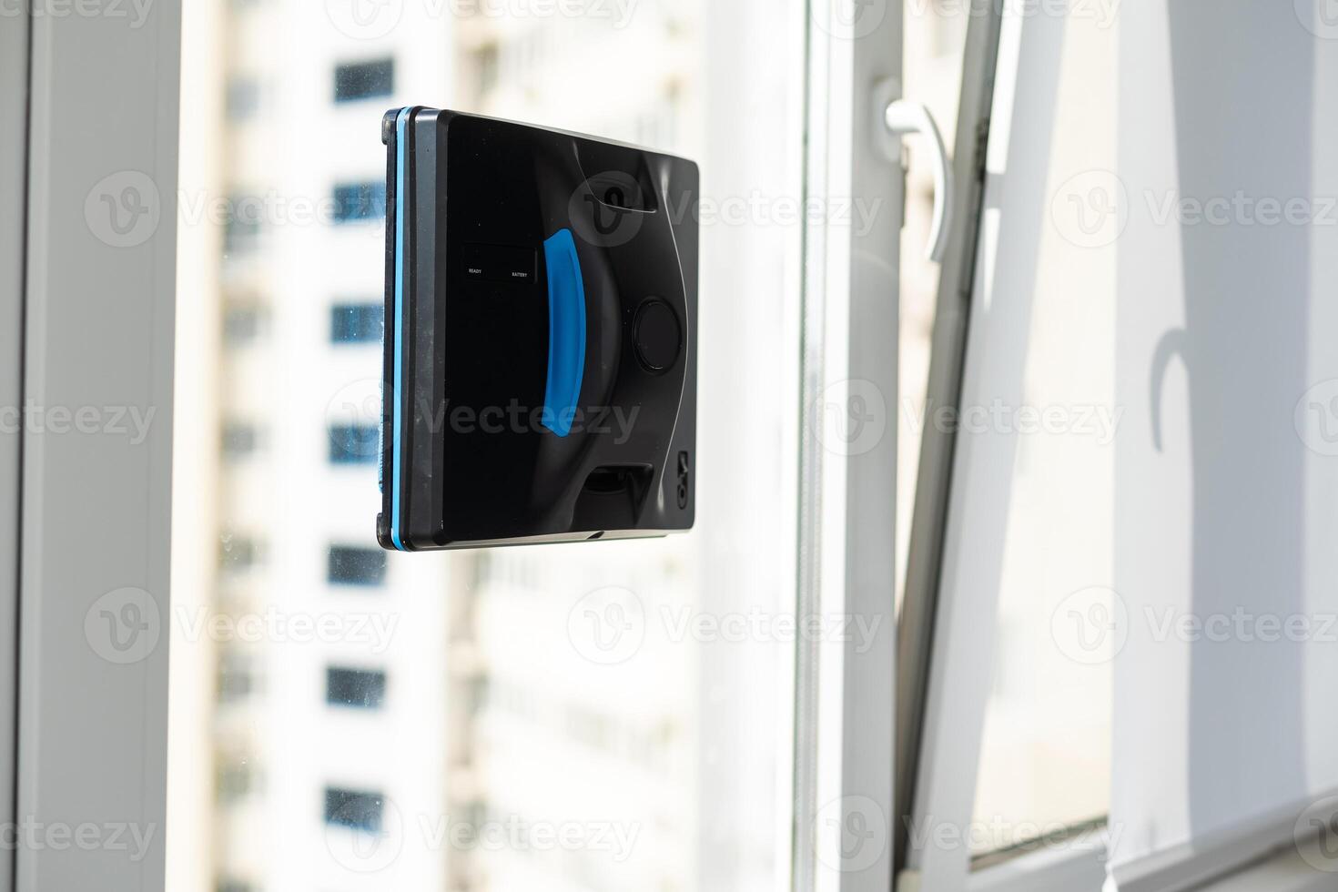Robot window cleaner work on dirty window. Cleaning the house with smart devices. Automatic vacuum robots for cleaning windows, an assistant for the home. photo