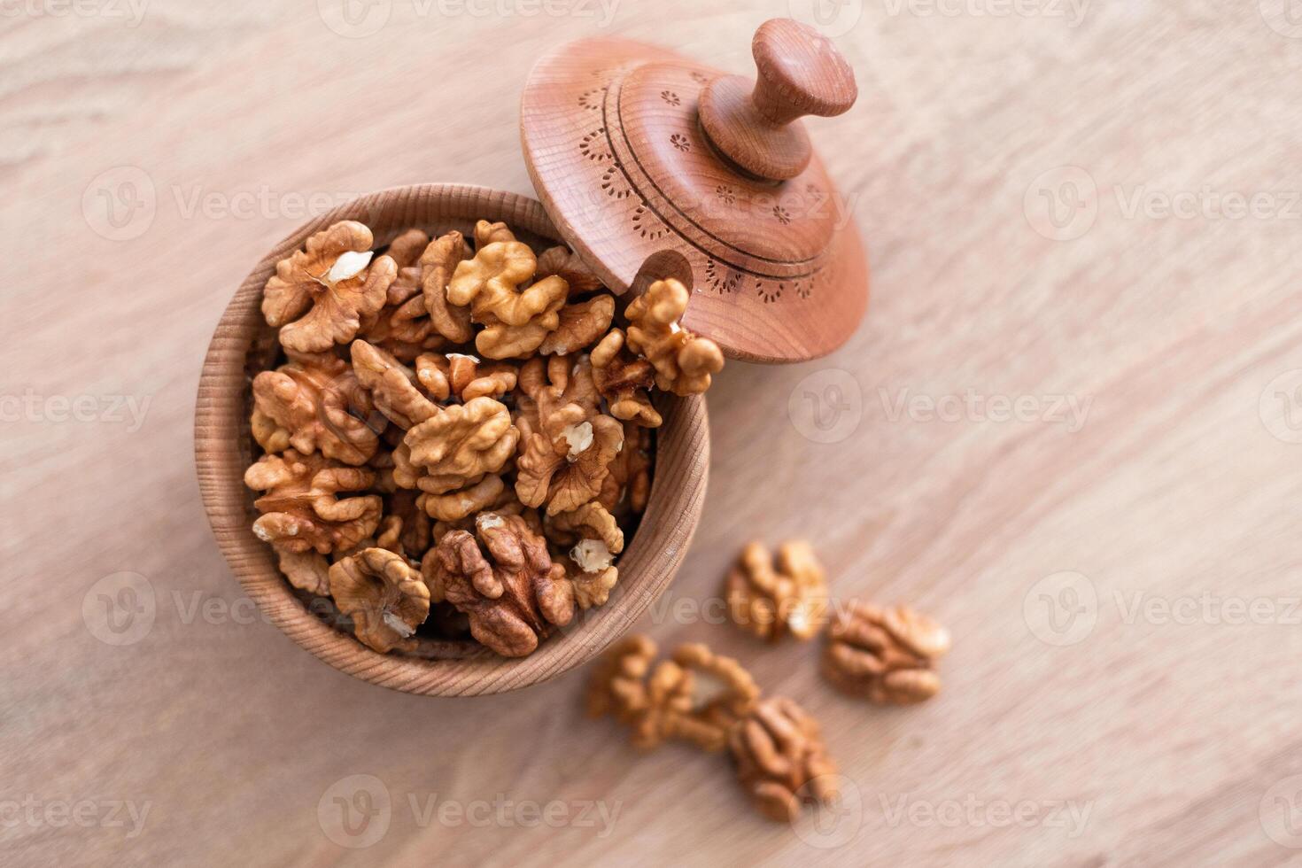 Whole walnuts and split on table. kernels of walnuts are dried and ready to eat. Soft focus. Blured picture. photo
