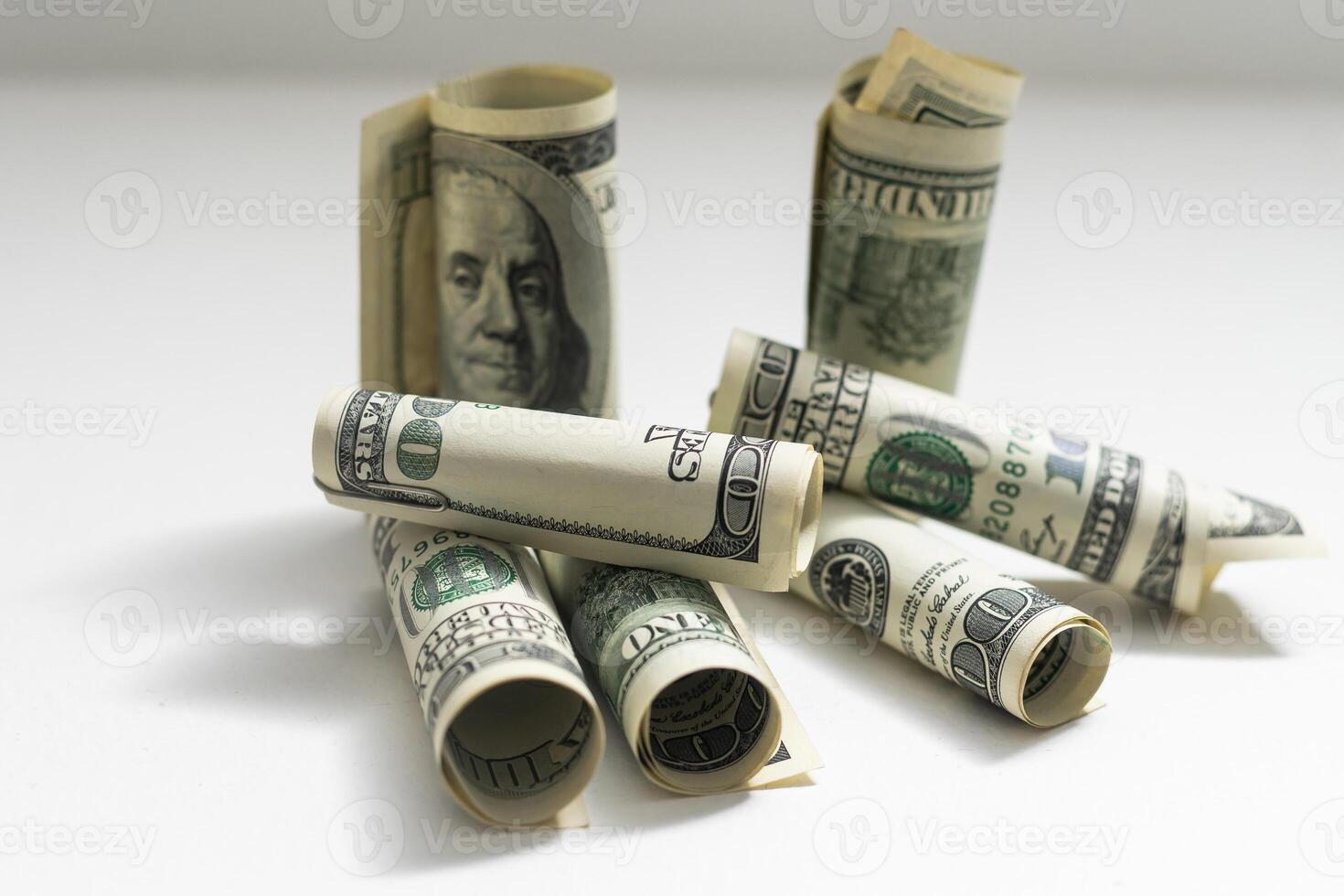 roles dollar notes in front of white background photo