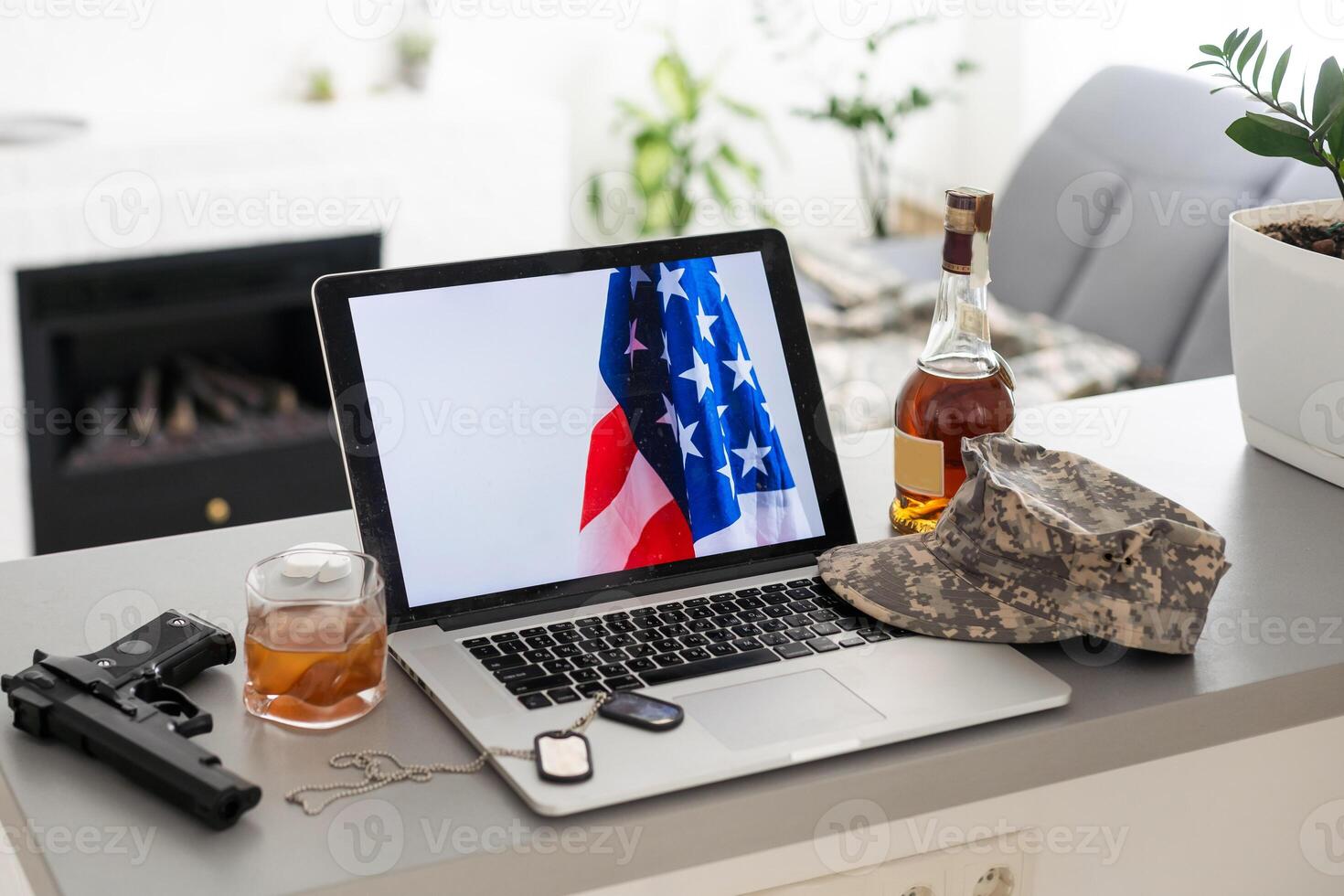 Modern workplace with laptop on table indoors. American flag on screen photo