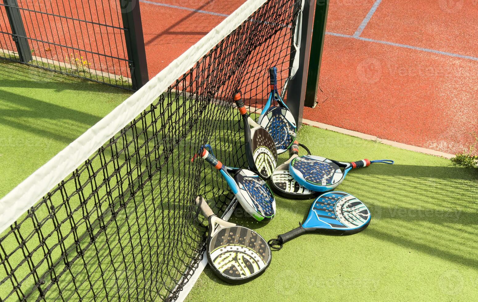White professional paddle tennis racket with natural lighting on blue background. Horizontal sport theme poster, greeting cards, headers, website and app photo