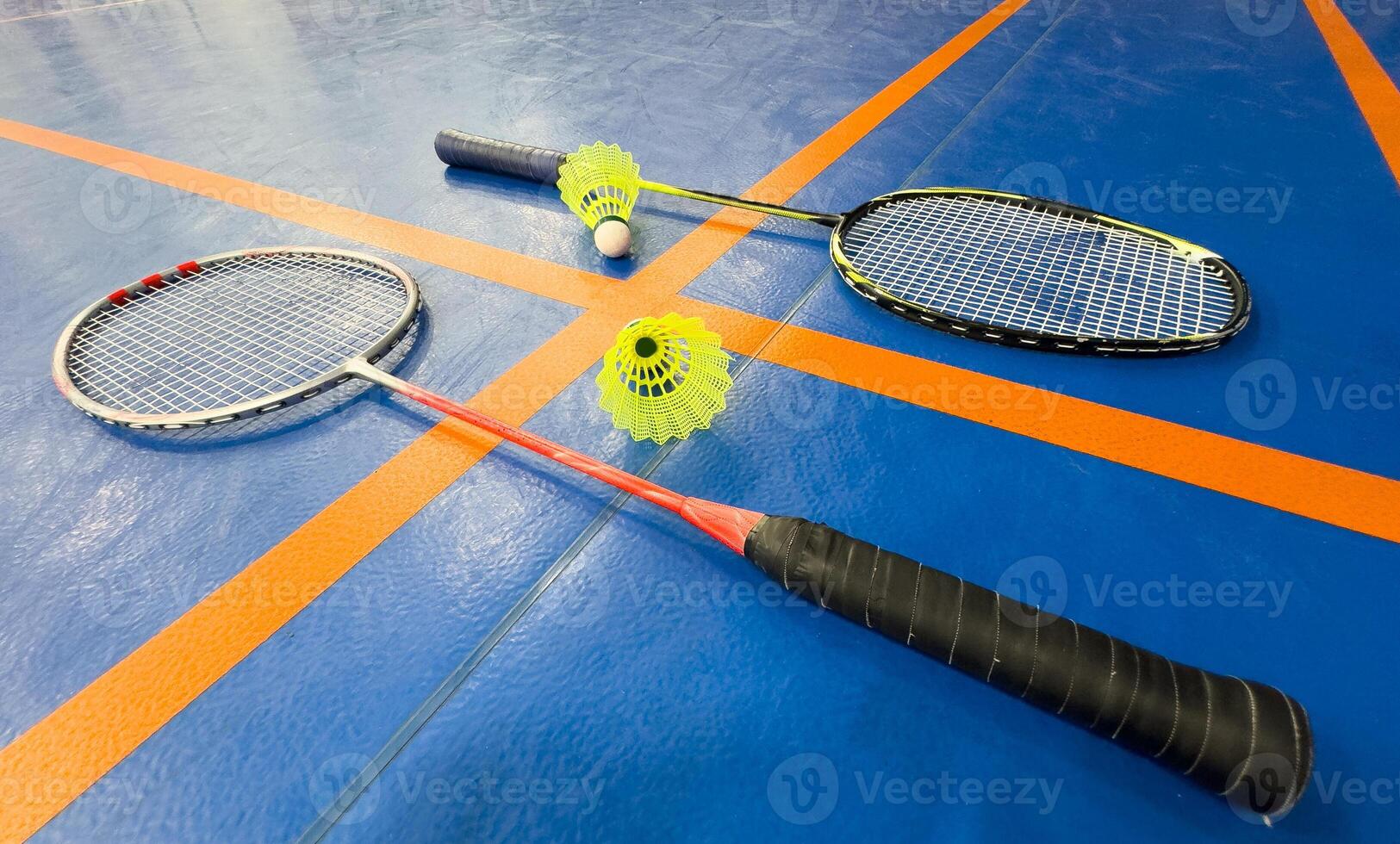 shuttlecock and badminton racket on the court photo