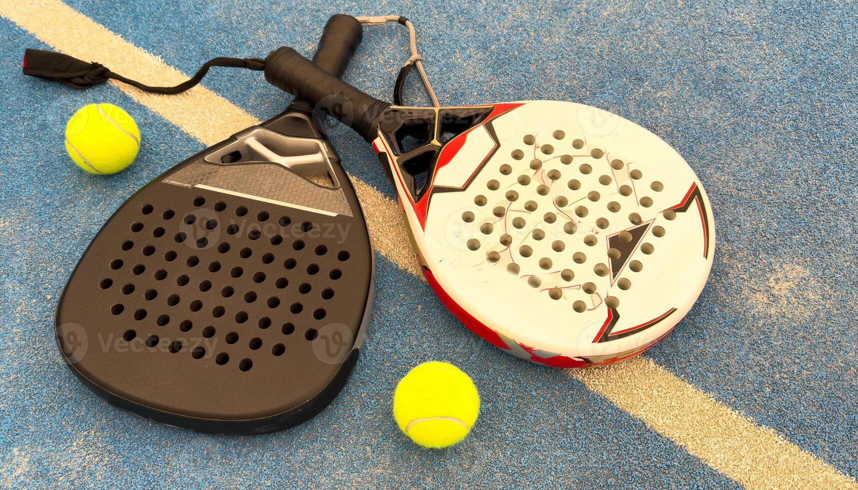 Paddle tennis. Paddel racket and ball in front of an outdoor court photo