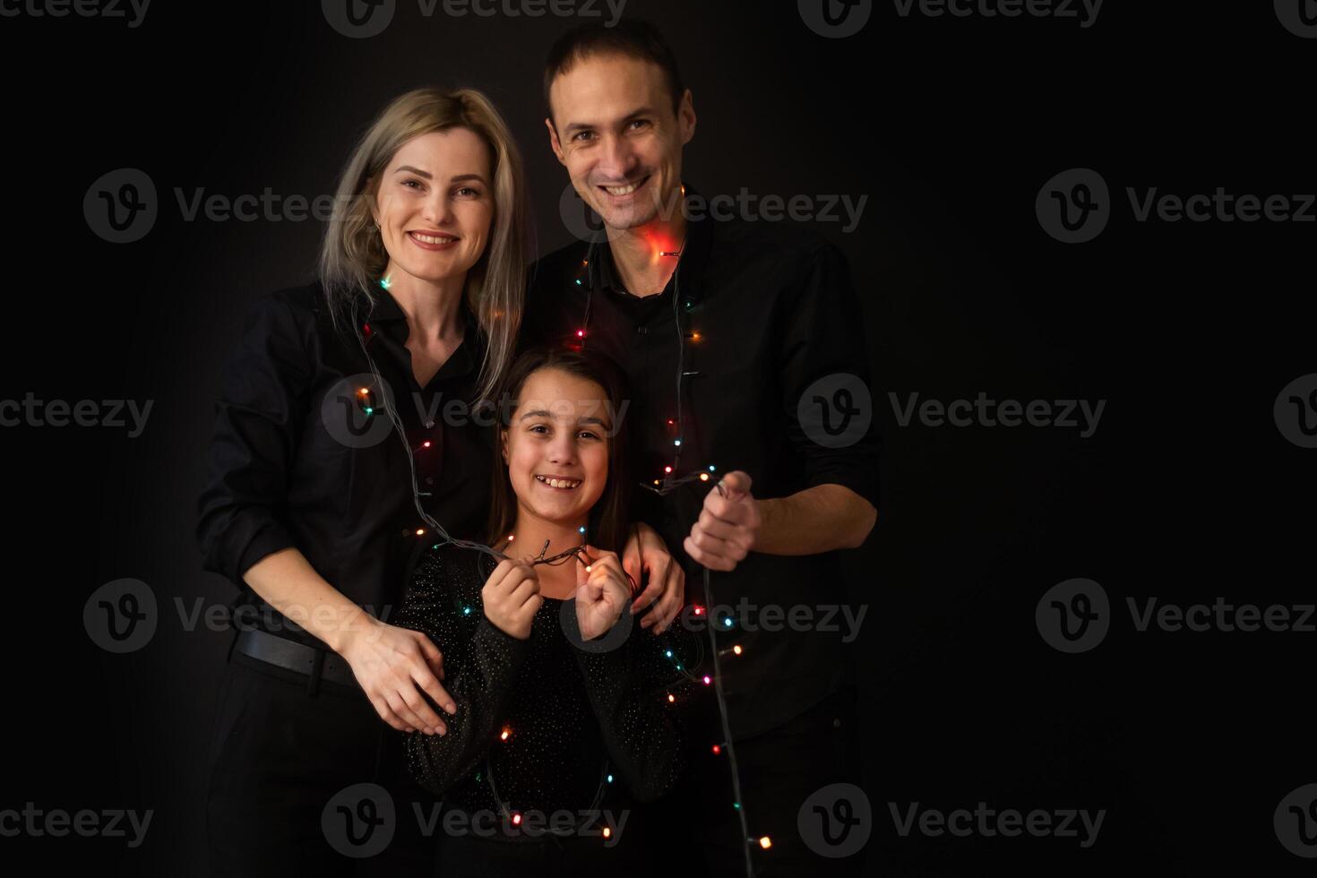 Family portrait on black background. photo