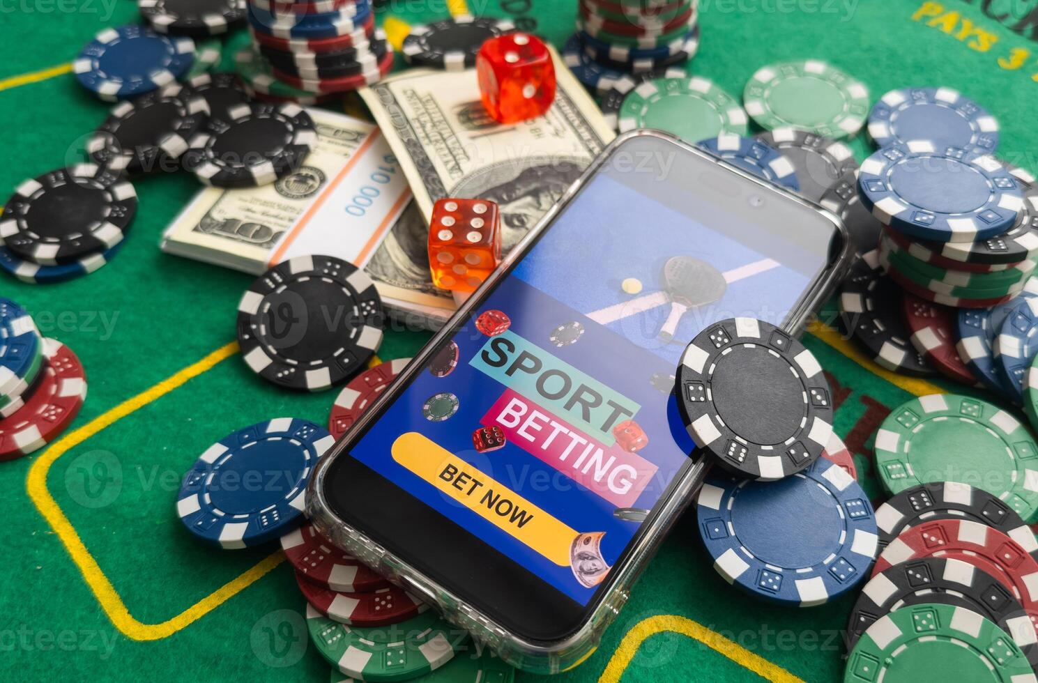 online casino smartphone with poker chips device over green table photo