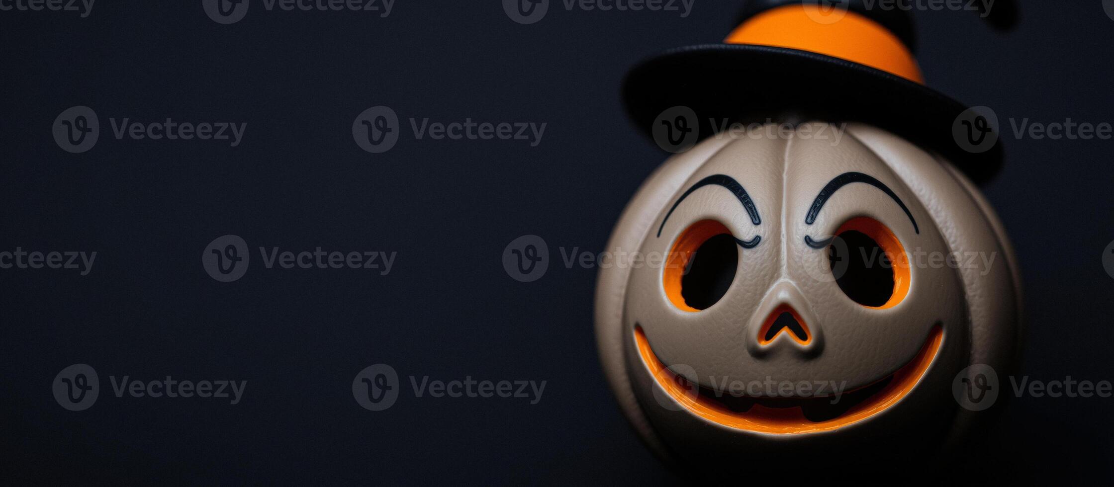 Close-up of a pumpkin with a hat on a black background photo