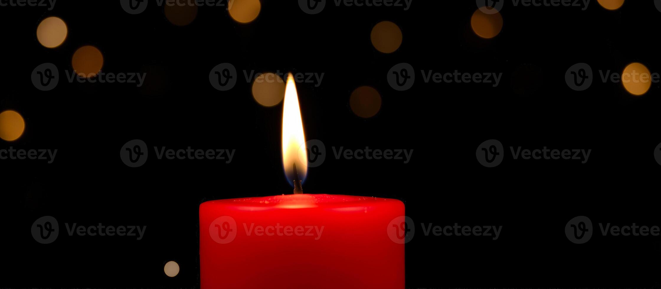 Red Candle Burning with Bokeh Lights in Background photo