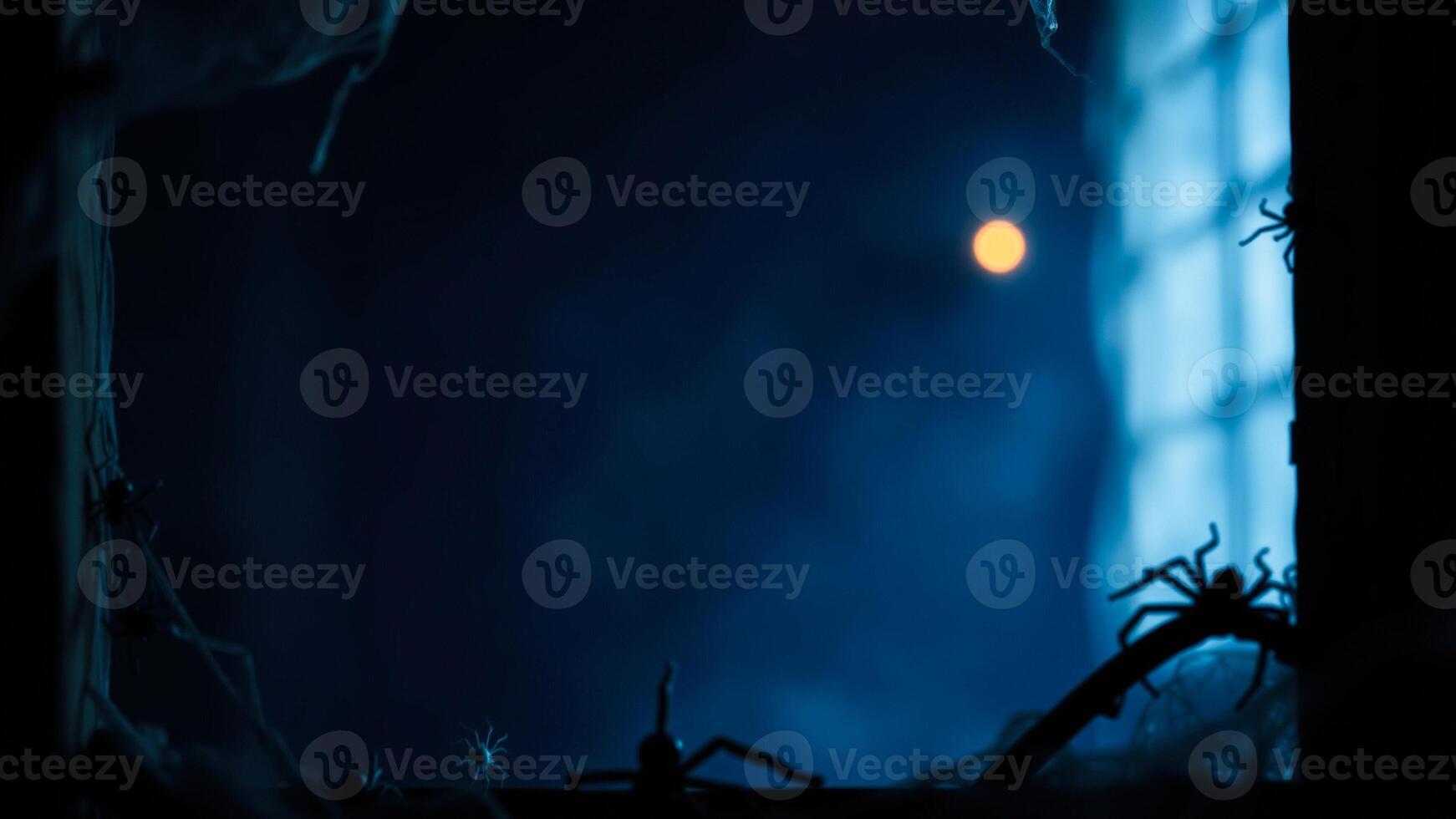 silhouettes spiders crawling on a window pane with a full moon photo