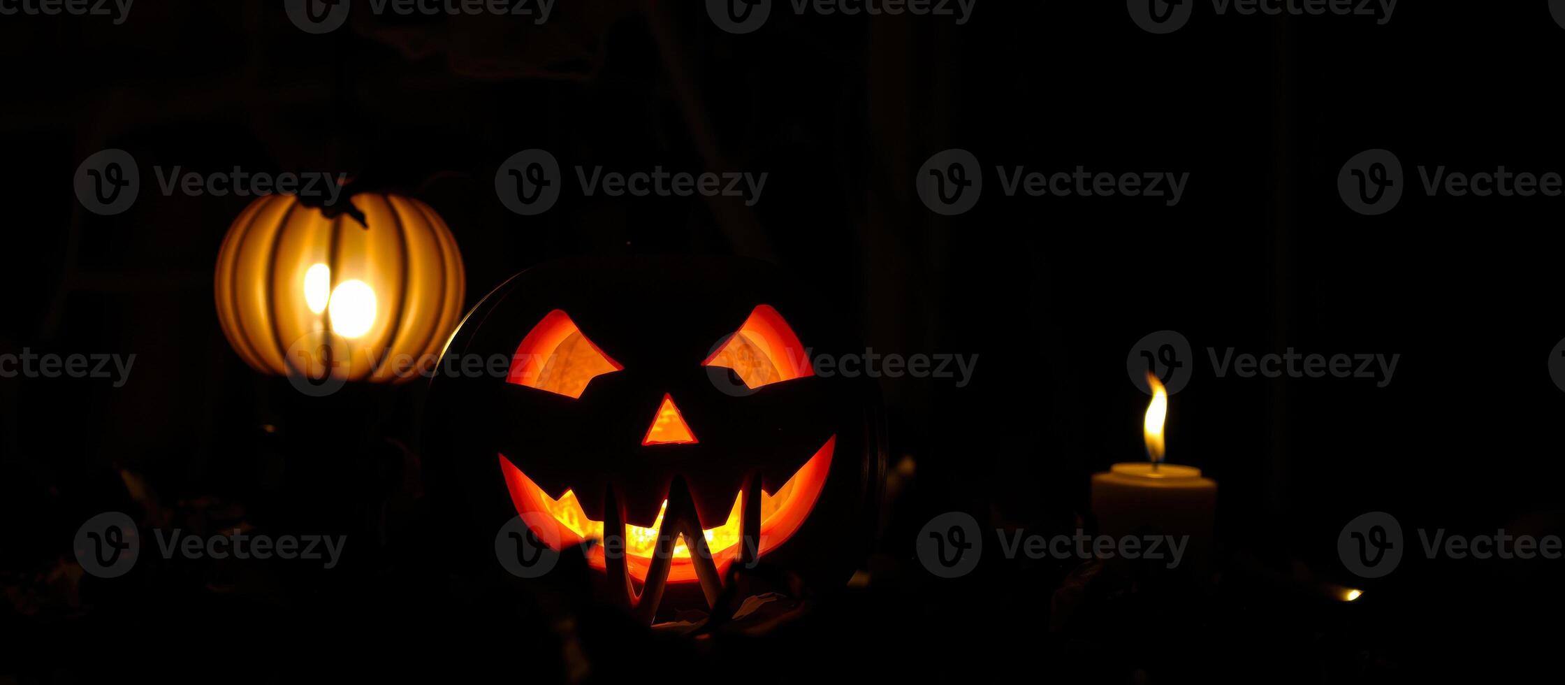 glowing jack-o-lantern casts an eerie light the darkness photo