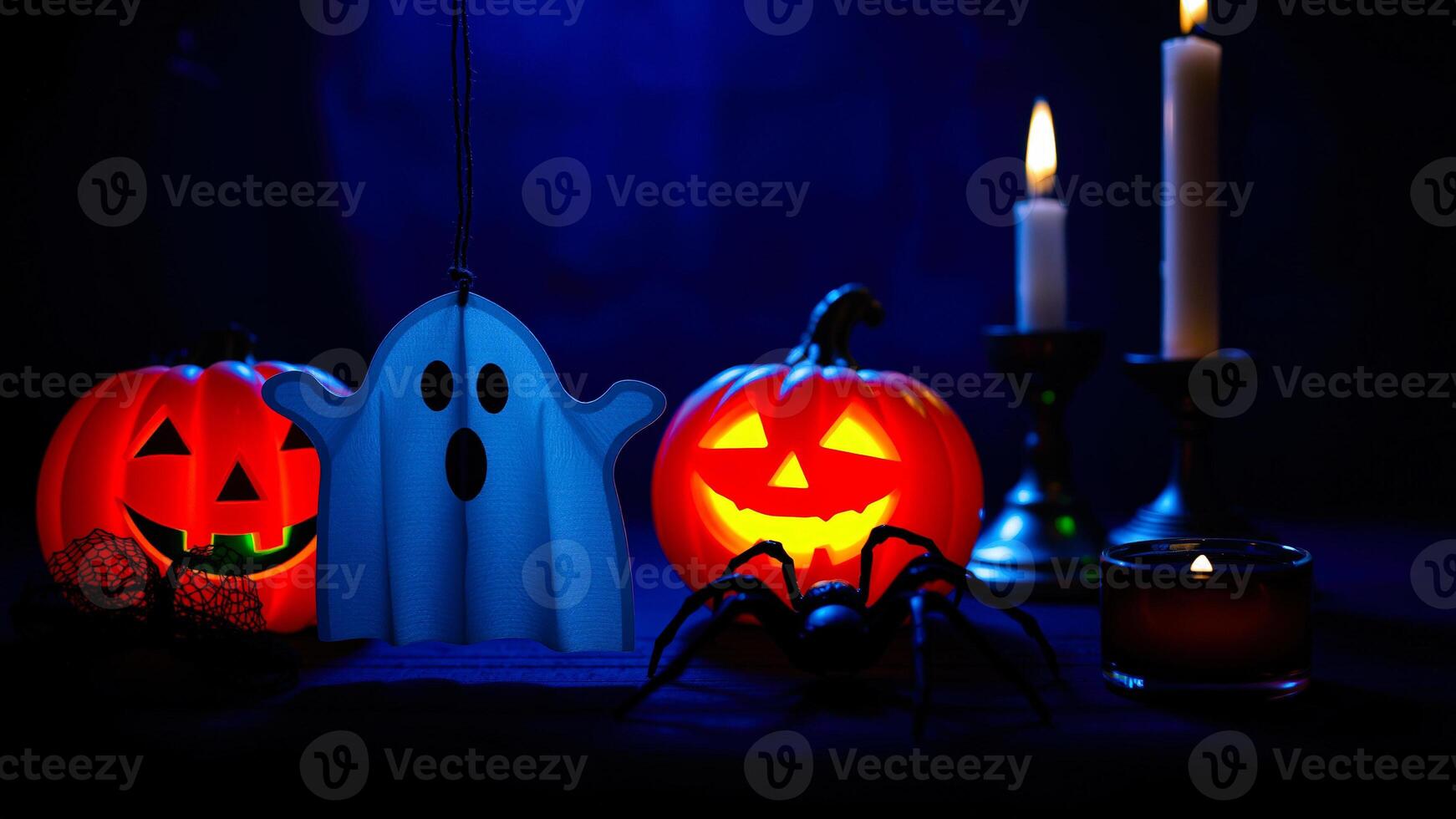halloween tabletop scene with jack-o'-lanterns a ghost a spider photo