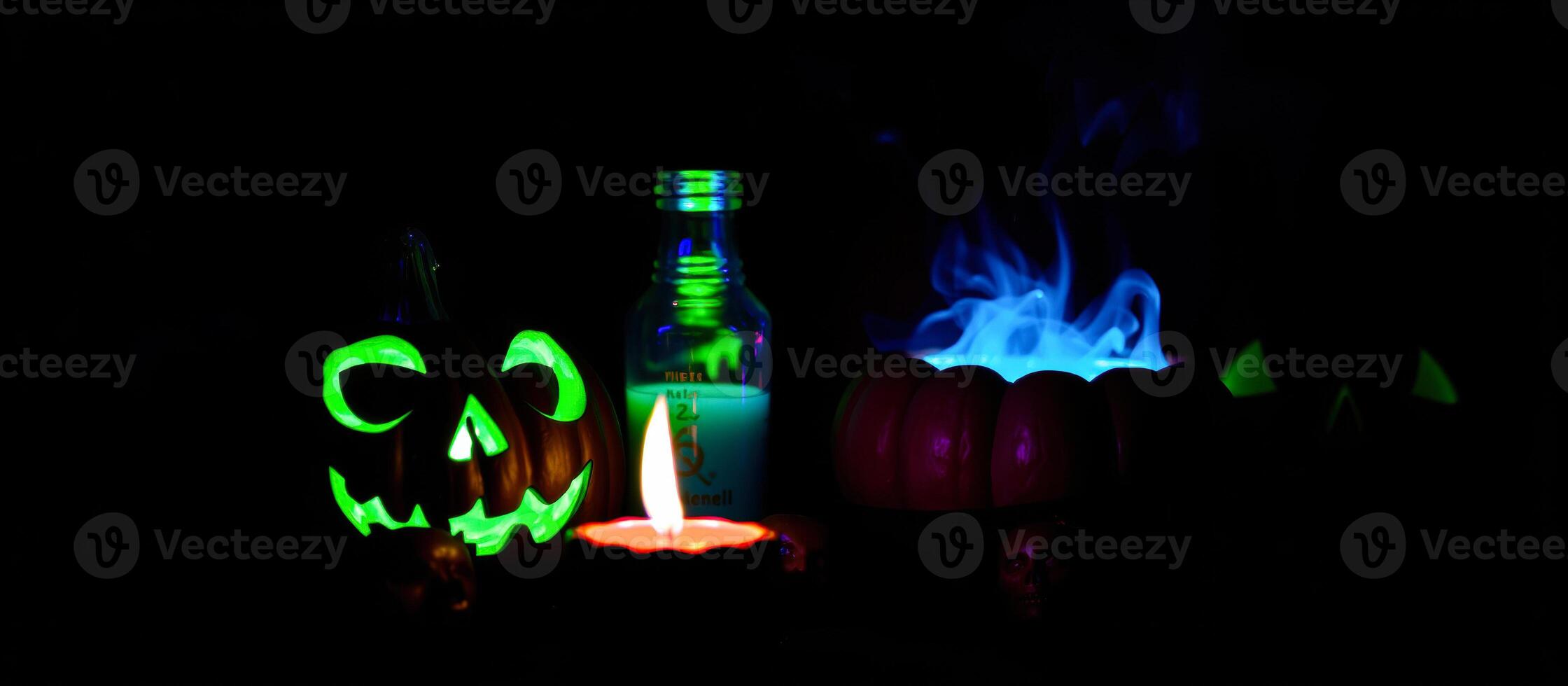 a halloween candle lit up with a pumpkin and a candle photo