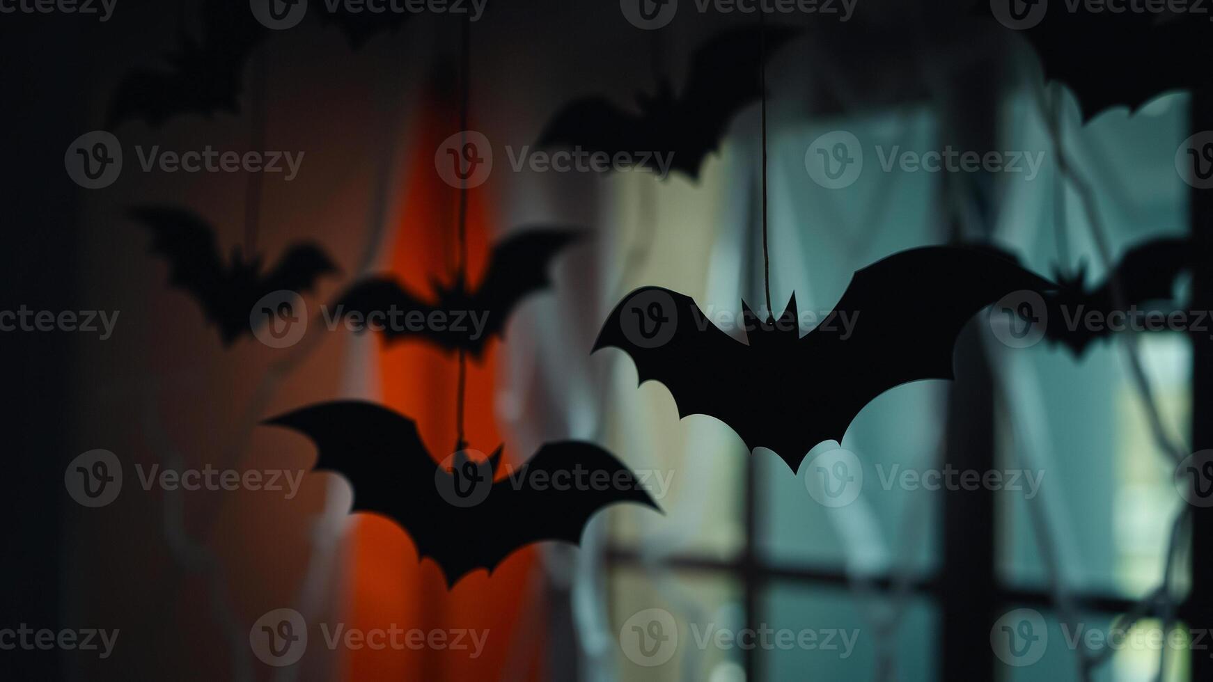 black paper bats hang from ceiling creating a spooky atmosphere photo