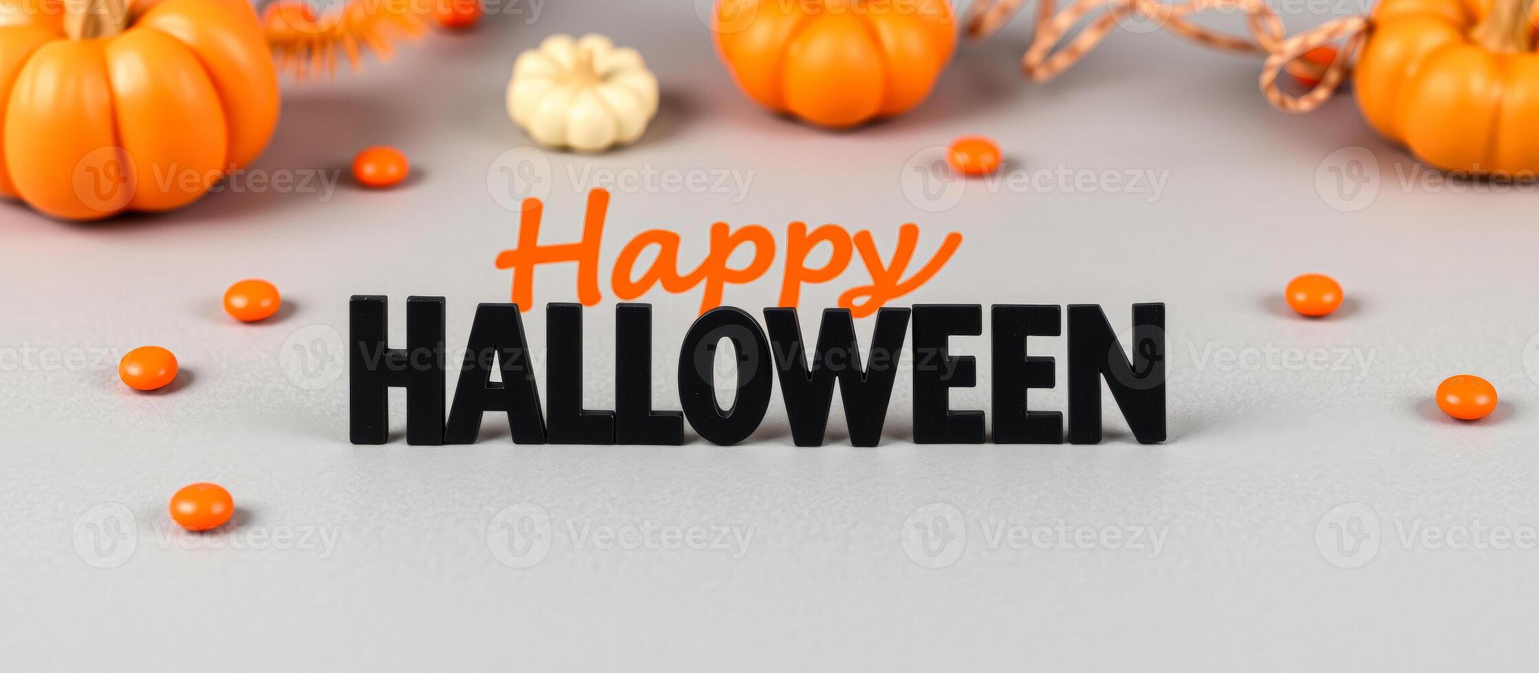 happy halloween greeting spelled out bold black letters with pumpkins candy photo
