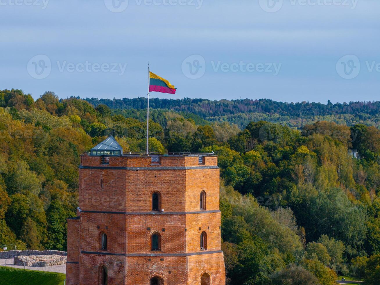Gediminas' Tower in Vilnius with Lush Green Forest Backdrop photo