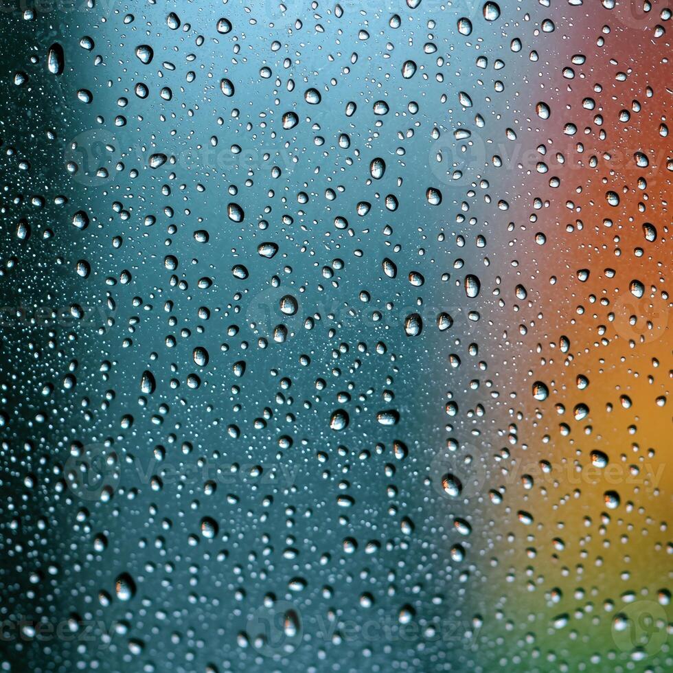 Raindrops on glass with colorful background photo