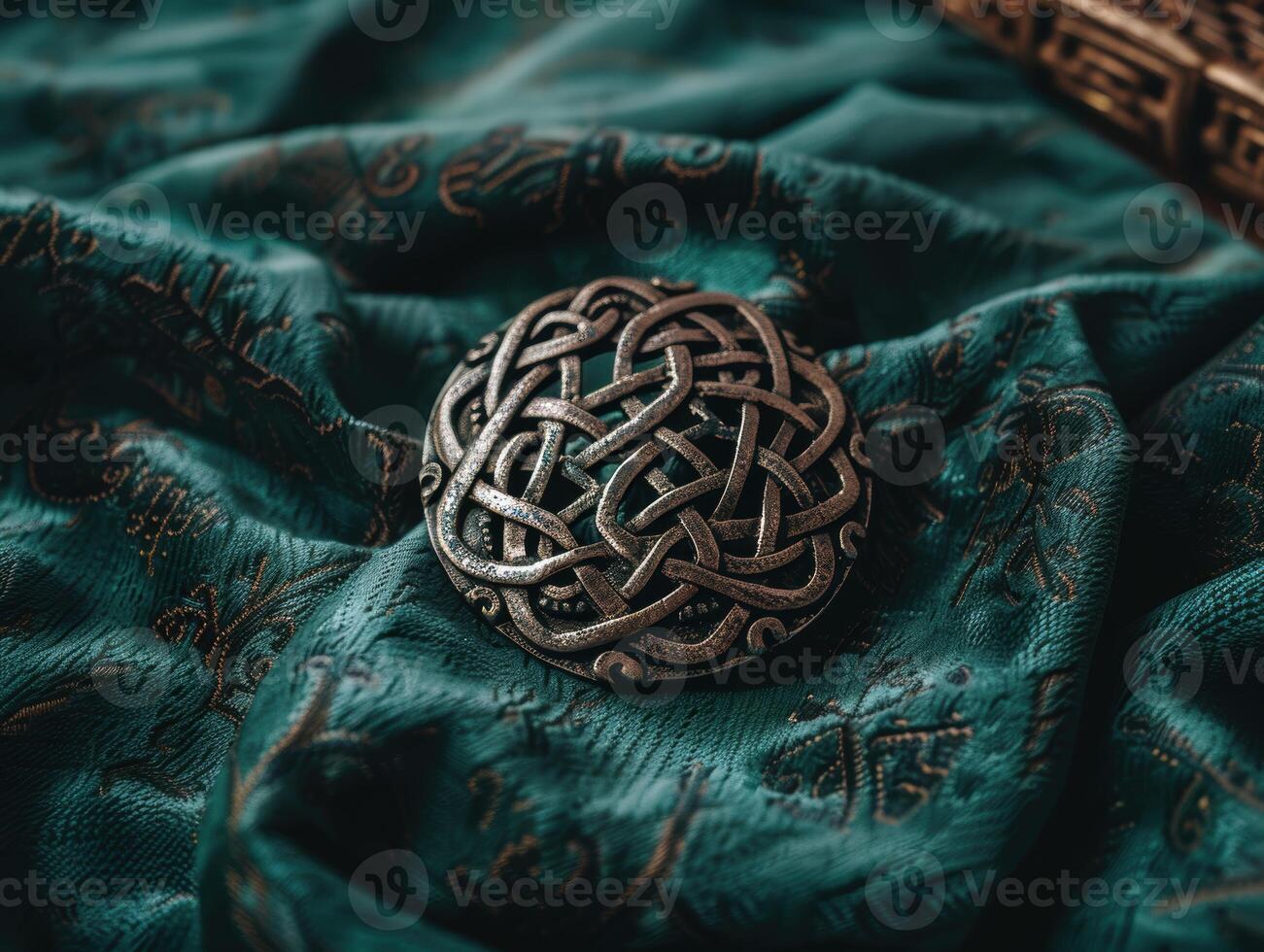 Intricate celtic knot on emerald green fabric photo