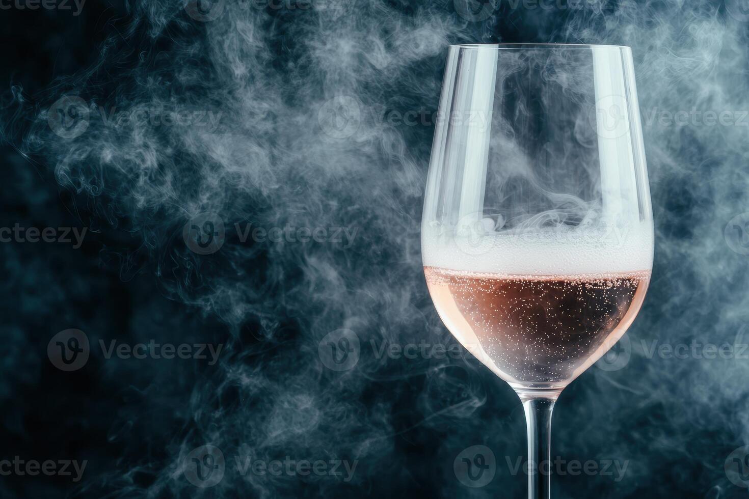 Elegant glass of sparkling rose wine with smoke effect photo