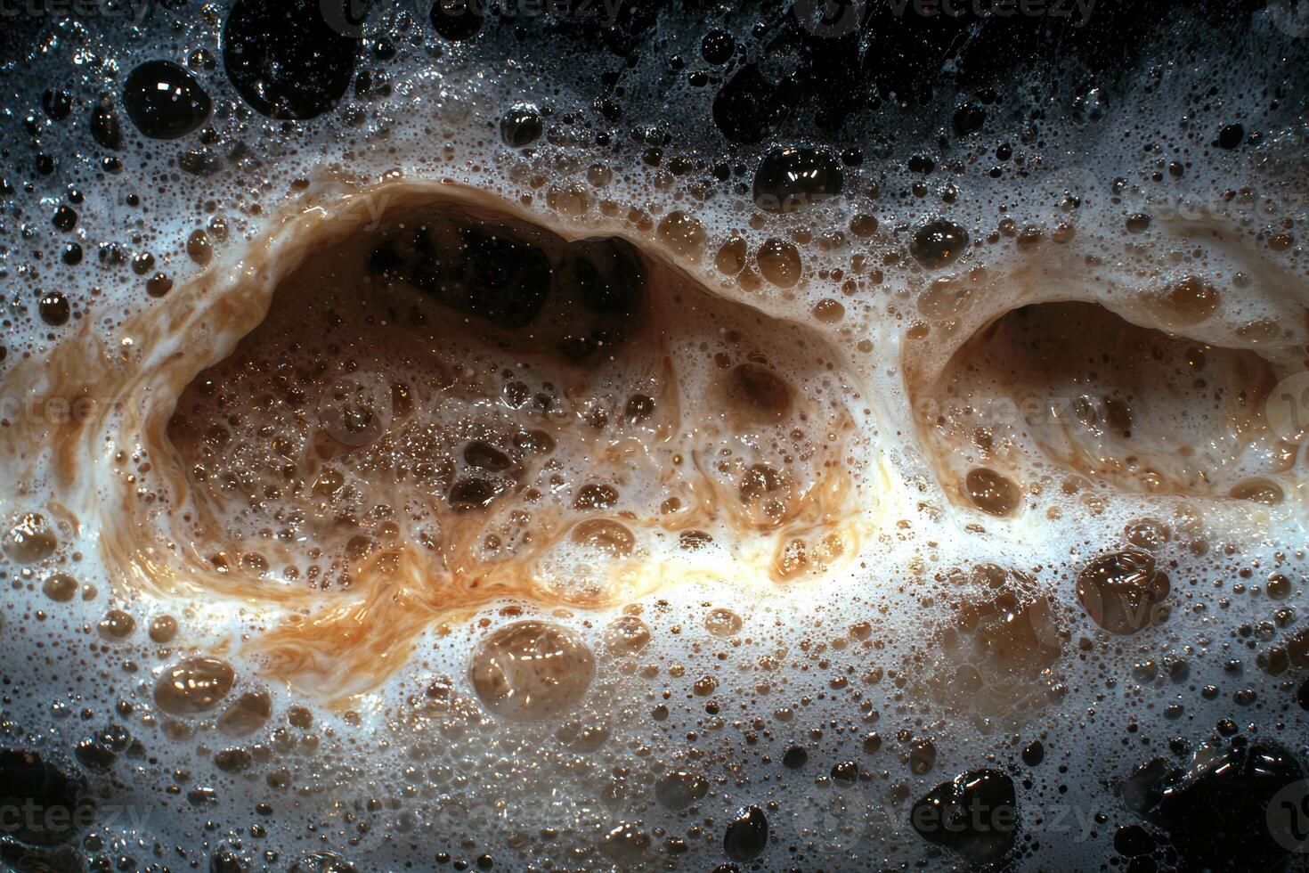 Closeup of bubbles and foam in a dark liquid photo