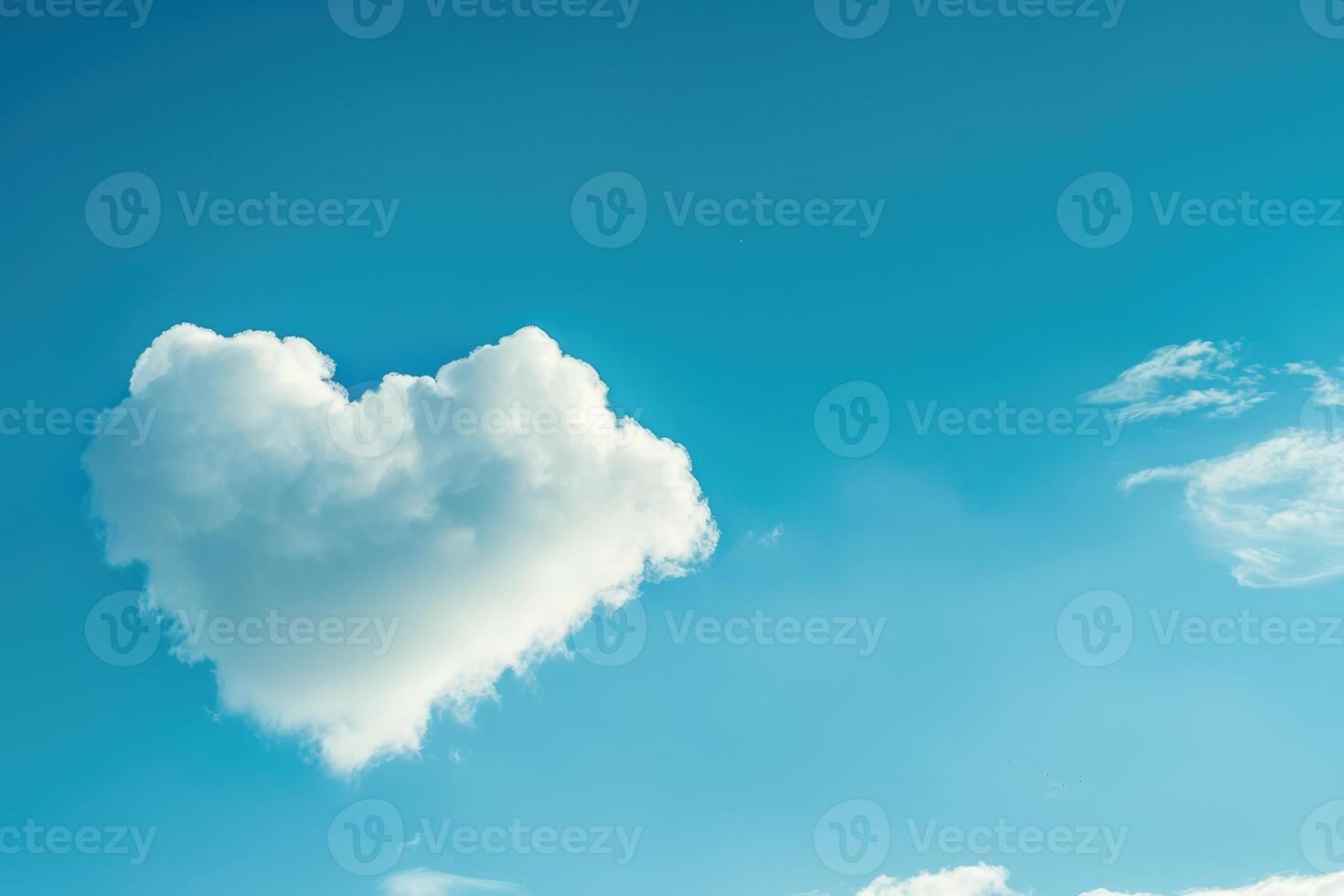 Heart shaped cloud in blue sky photo